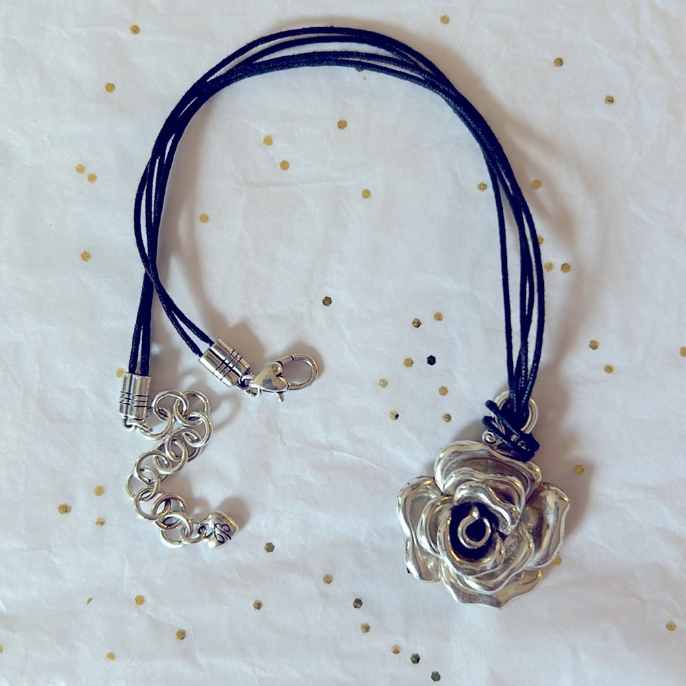 A lovely silver flower necklace with tiny heart accents.